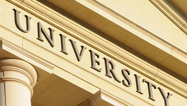 university sign on a stone building