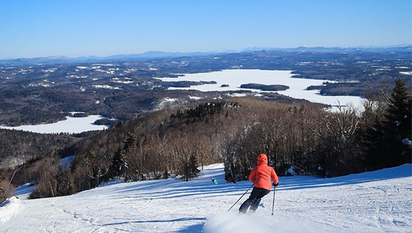 a skier going down a mountain at Mount Sunapee Ski Resort