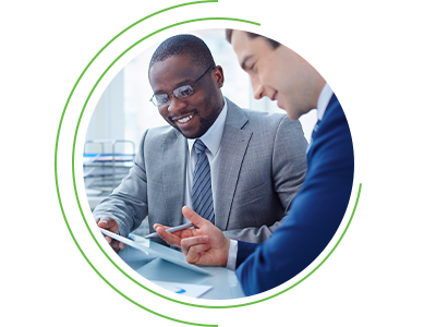 Two business professionals reviewing documents together on a tablet, smiling, framed within a circular graphic.
