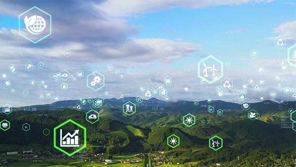 Landscape of green mountains and a rural valley with scattered buildings, overlaid with glowing hexagonal icons representing technology, data, energy, and sustainability concepts. Landscape of green mountains and a rural valley with scattered buildings, overlaid with glowing hexagonal icons representing technology, data, energy, and sustainability concepts.